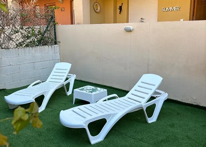 Bajo con jardín a pie de playa y piscina comunitaria con jacuzzi